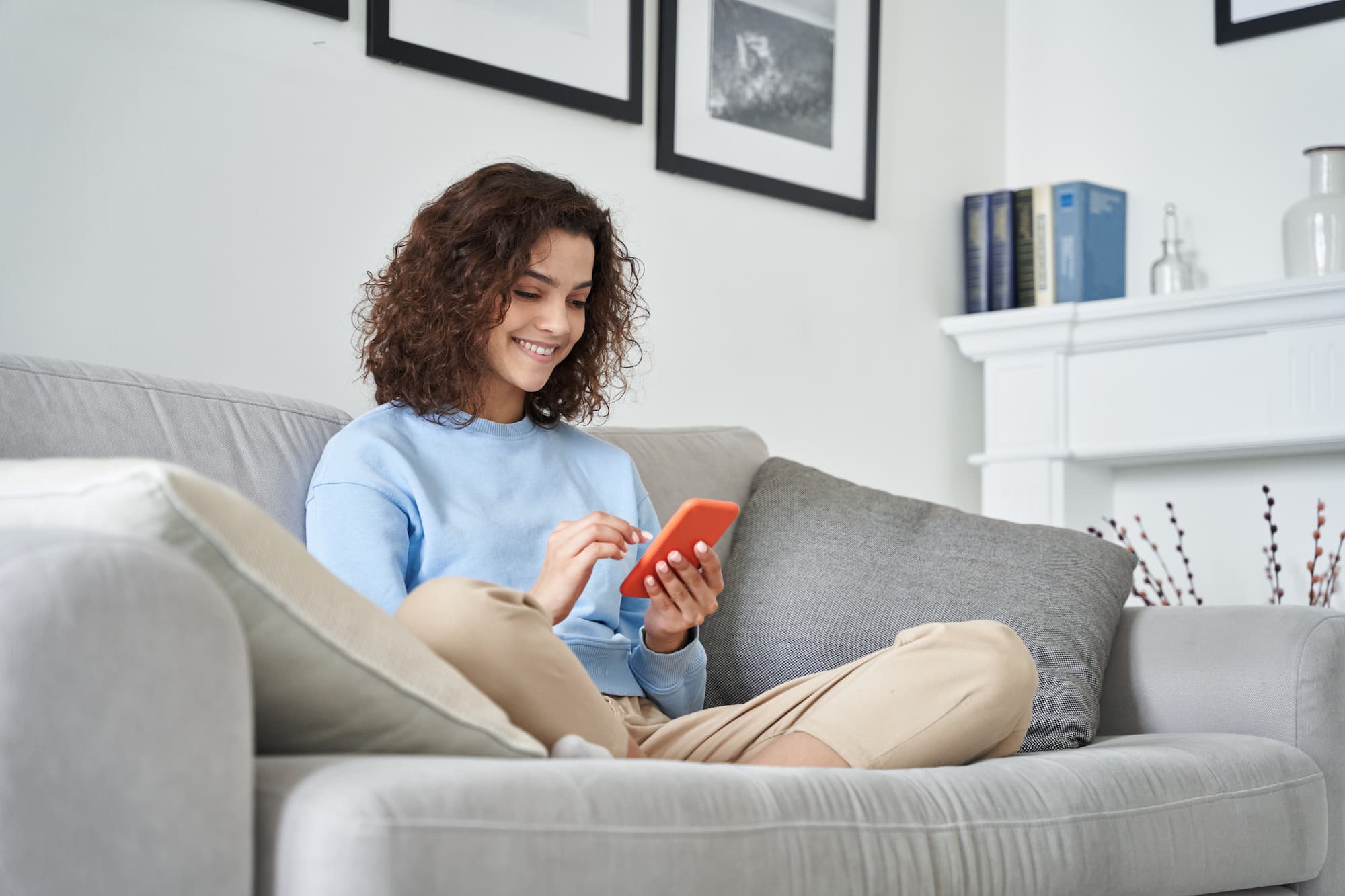 Happy woman using mobile phone